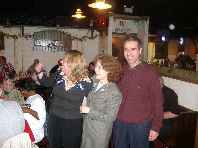 Mary Beth Carozza of Governor Ehrlich's office joins Bonnie and Luis Luna in watching the results.
